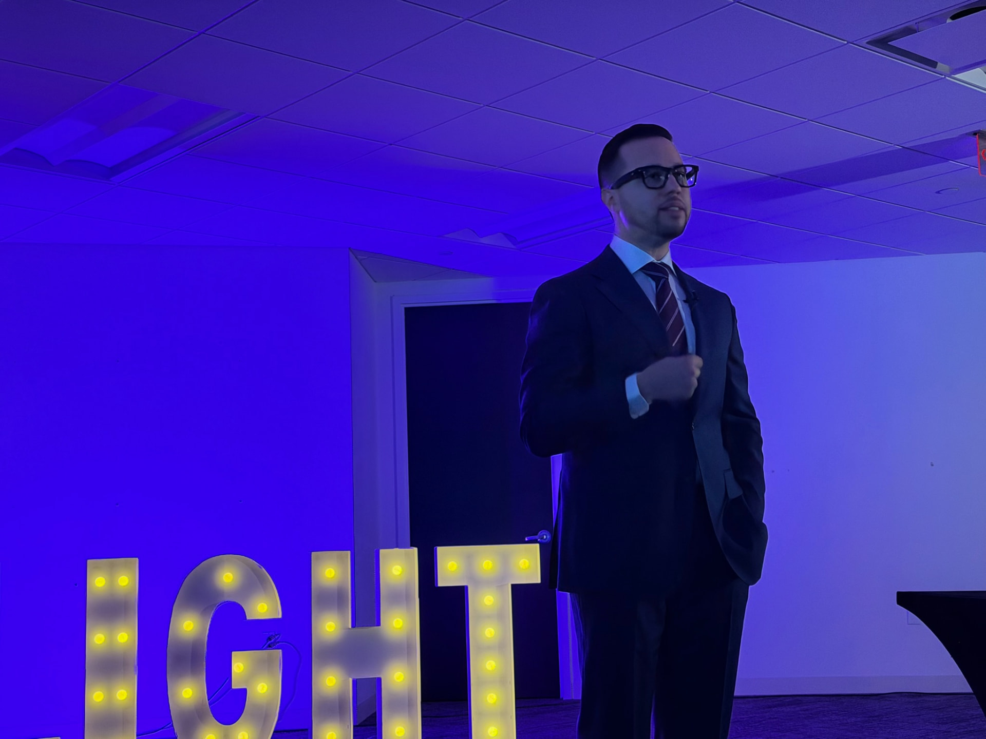 Franco facilitating on stage at a Project Light event