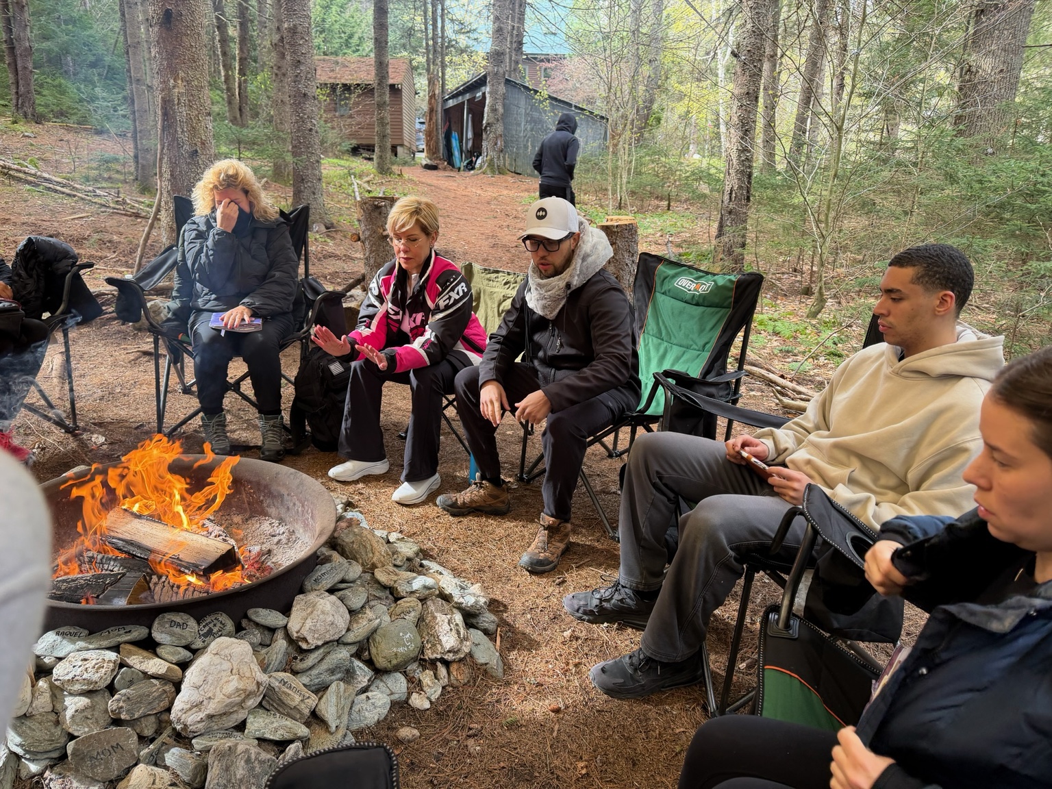 A community gathered around a fire circle